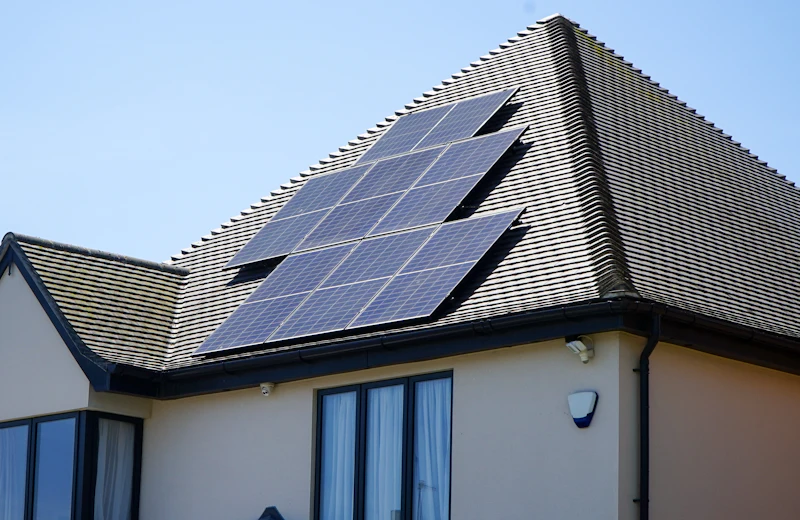Solar panels on the roof of a detached house in clear weather